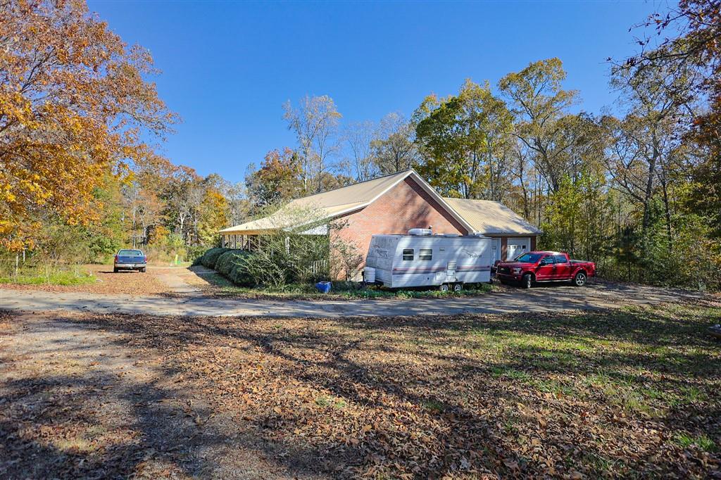 760 Breedlove Road Ball Ground, GA 30107 - Photo 5 of 18 a front view of a house with a yard and garage