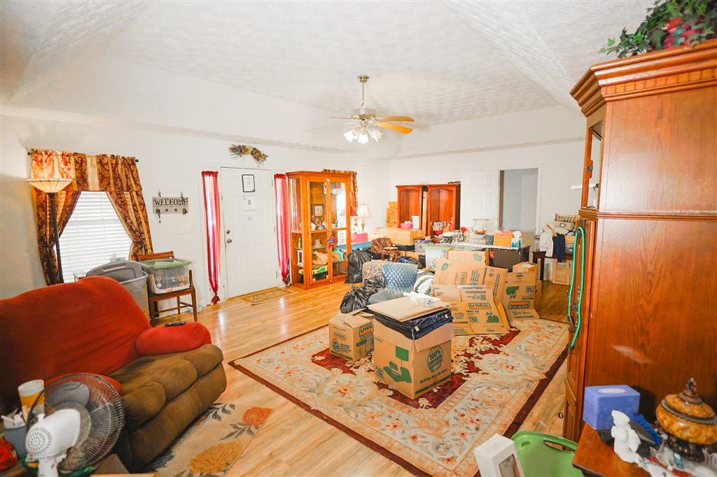 760 Breedlove Road Ball Ground, GA 30107 - Photo 7 of 18 a living room with furniture rug and a chandelier