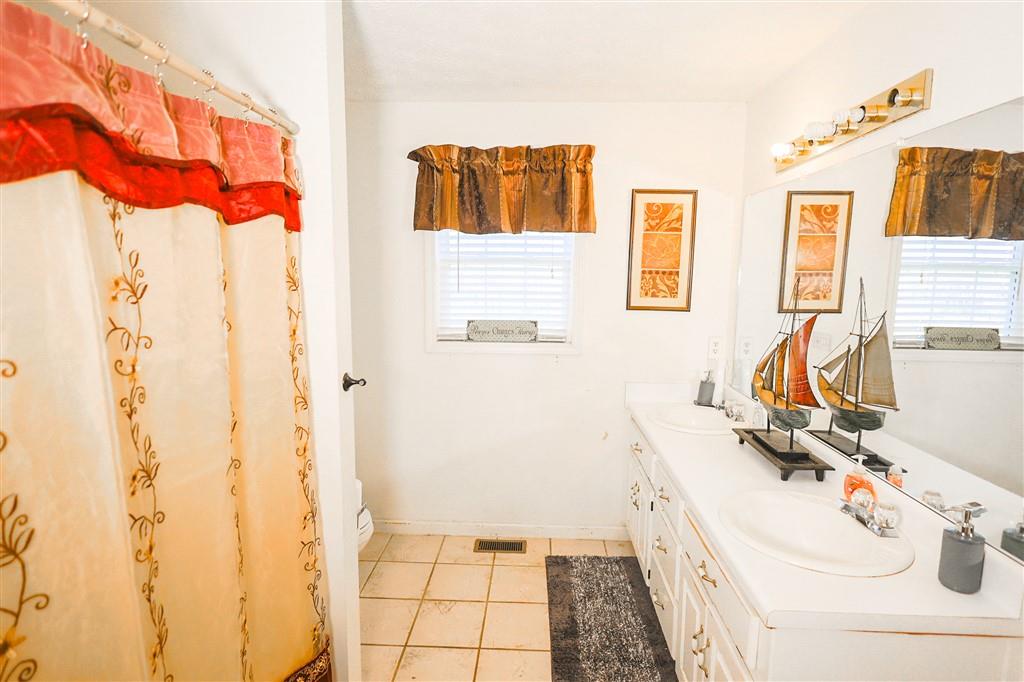 760 Breedlove Road Ball Ground, GA 30107 - Photo 8 of 18 a bathroom with a sink and a mirror