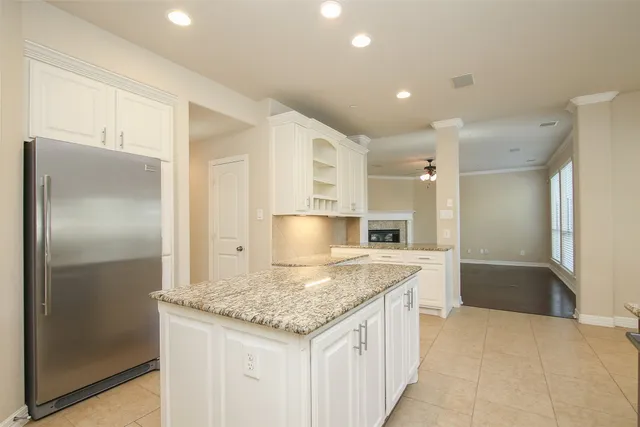 a kitchen with a refrigerator a sink and a cabinets