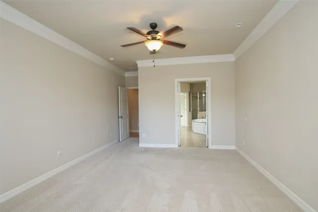 a view of an empty room with a ceiling fan