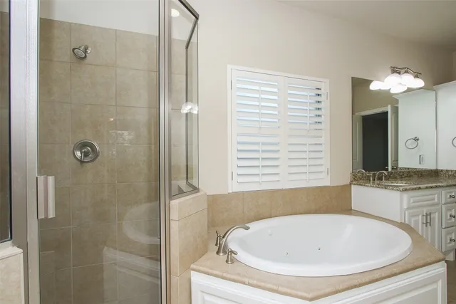 a bathroom with a tub sink and shower