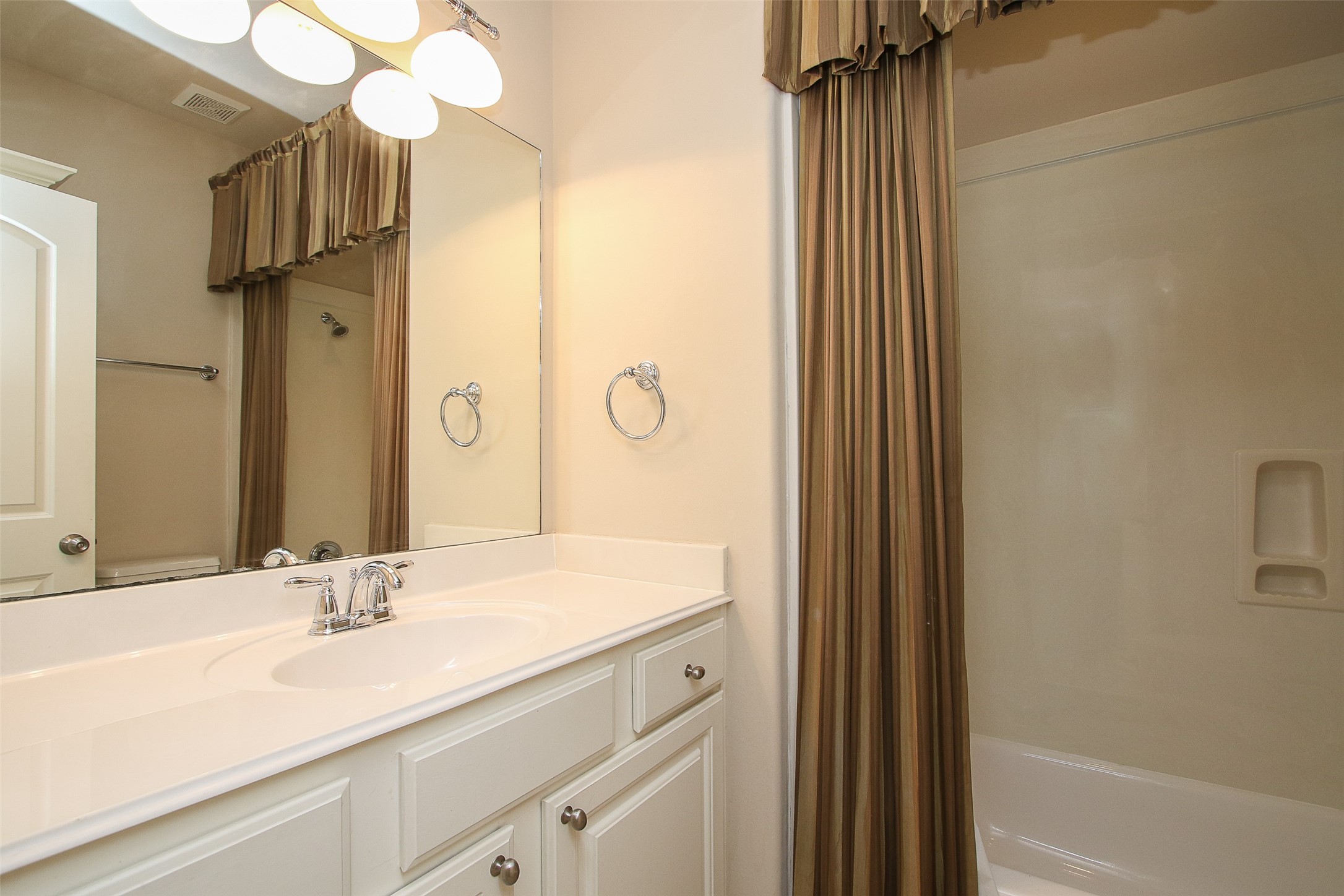 11722 Spriggs Way Houston, TX 77024 - Photo 29 of 49 a bathroom with a sink and a mirror