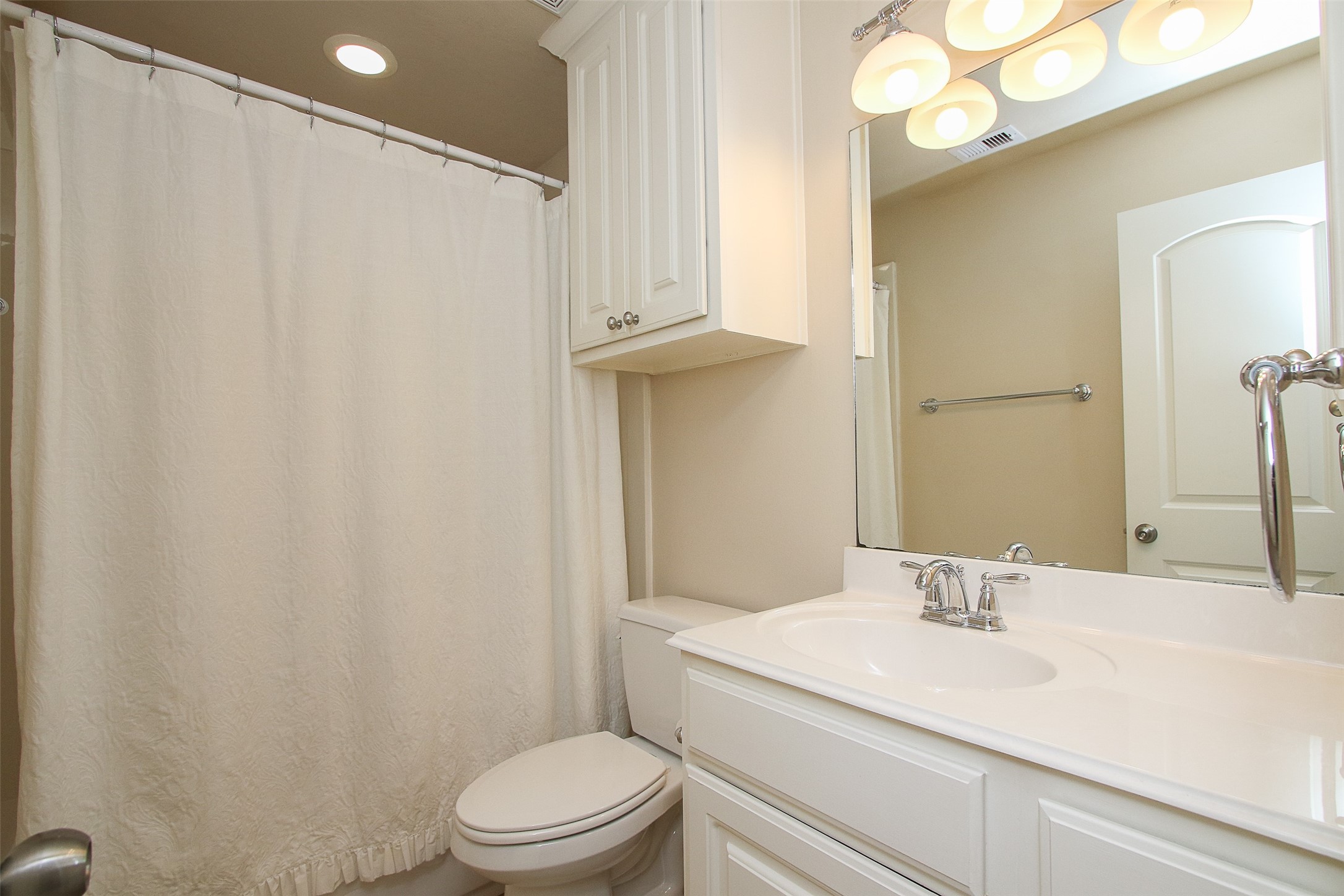 11722 Spriggs Way Houston, TX 77024 - Photo 36 of 49 a bathroom with a sink a toilet and a mirror