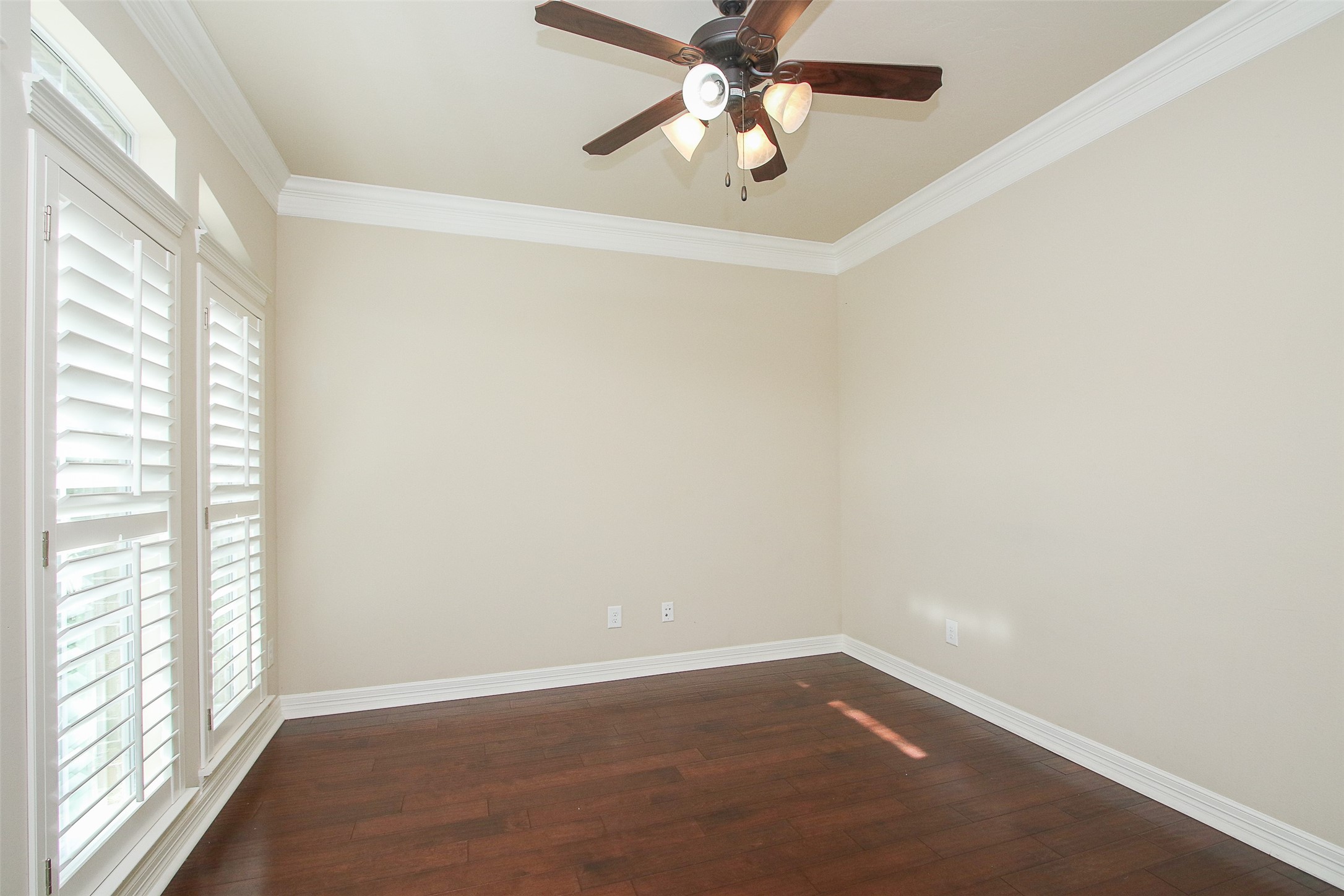 11722 Spriggs Way Houston, TX 77024 - Photo 5 of 49 an empty room with a window and a fan