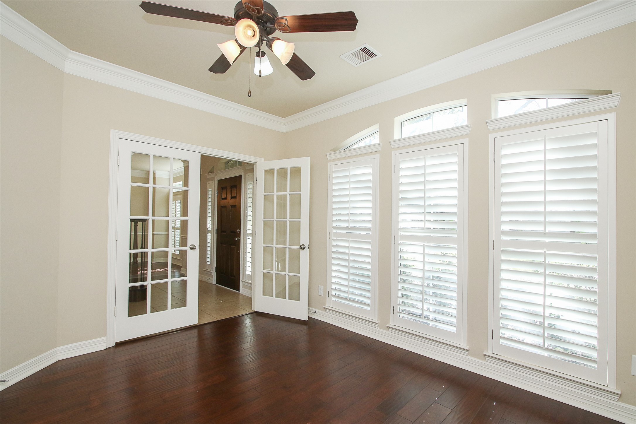 11722 Spriggs Way Houston, TX 77024 - Photo 6 of 49 a view of an empty room with a window and wooden floor