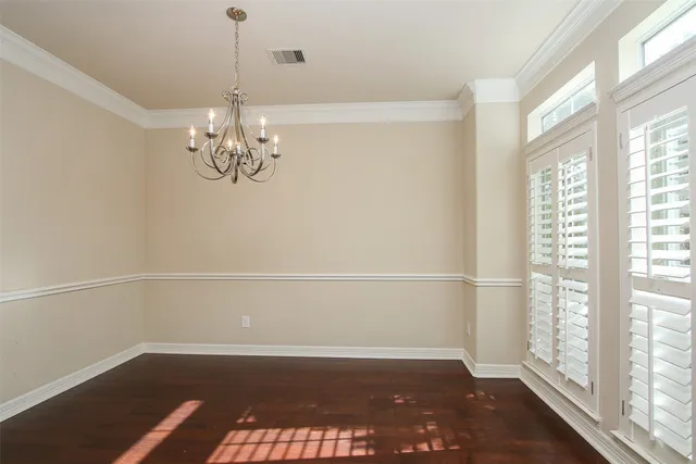 a view of a room with wooden floor and windows