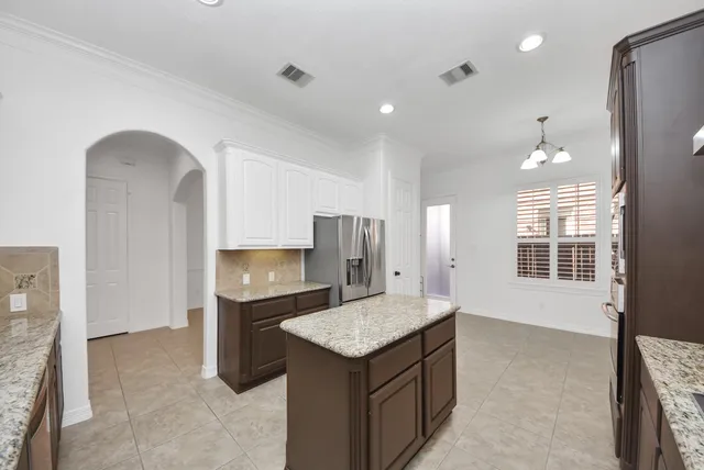 a kitchen with a stove a refrigerator and a fireplace