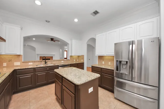 a kitchen with a sink refrigerator and microwave