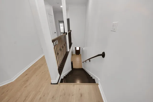 a view of entryway and hall with wooden floor