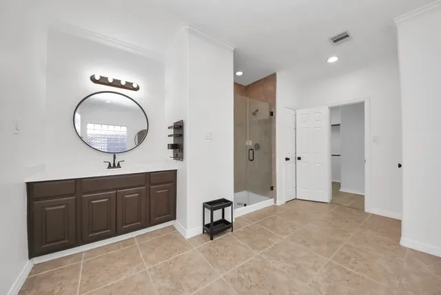 a room with a mirror and cabinets