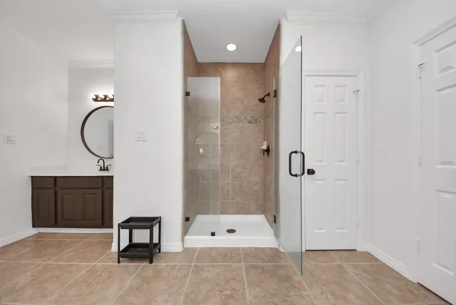 a bathroom with a tub shower and sink