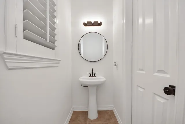 a bathroom with a sink a mirror and vanity