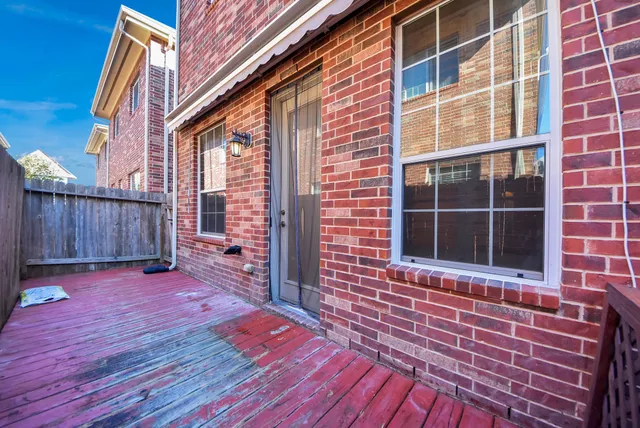 a view of front door of house with wooden floor and a yard