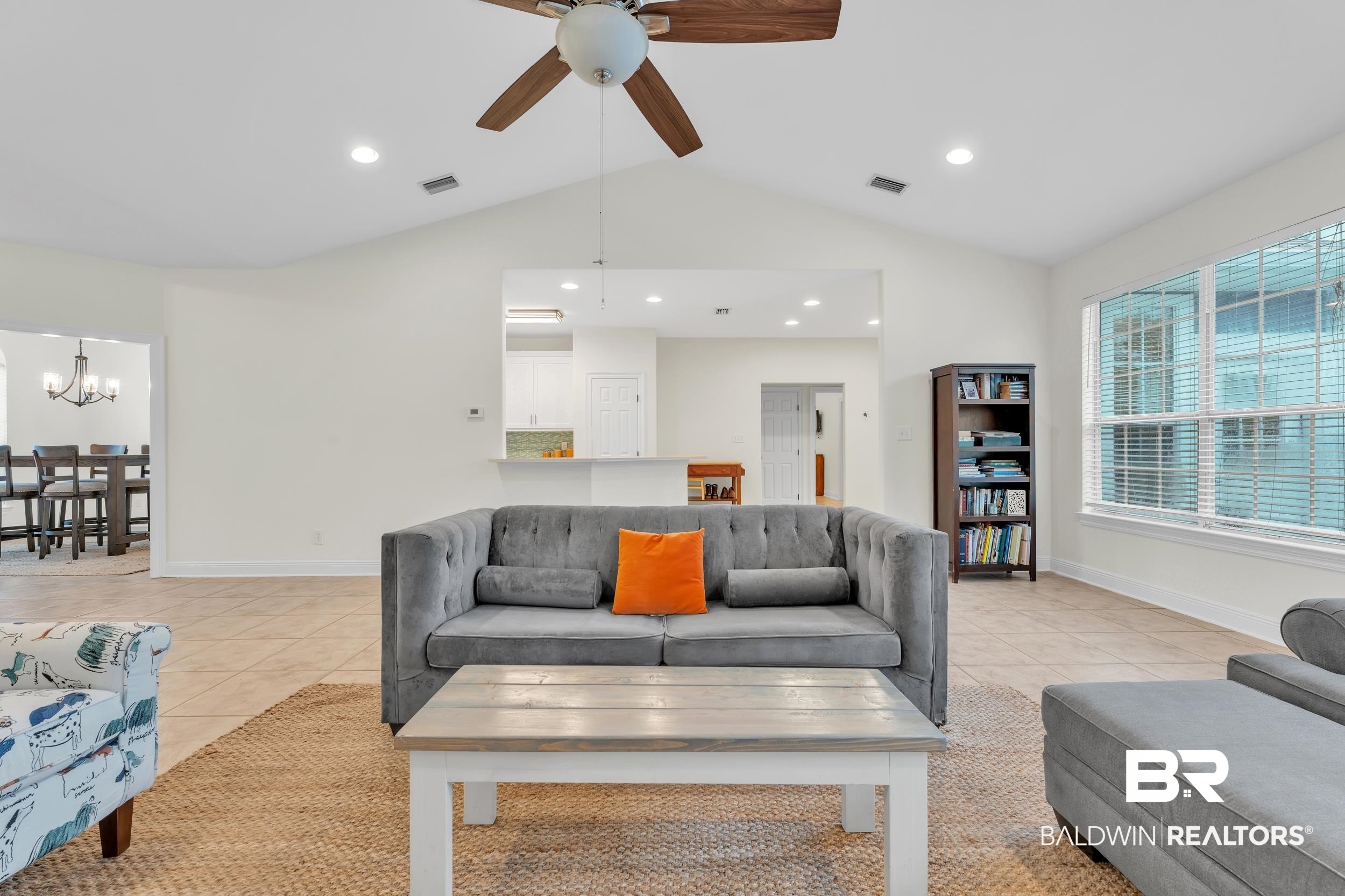 4606 Osprey Drive Orange Beach, AL 36561 - Photo 17 of 44 Living area featuring a ceiling fan, light tile patterned flooring, a chandelier, lofted ceiling, and recessed lighting