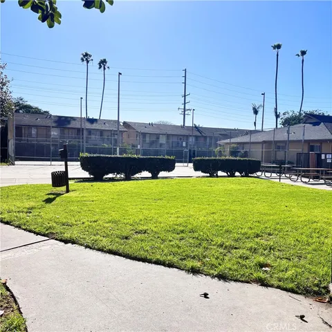 a view of a house with a yard and sitting area