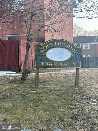 a view of a street sign under a large tree