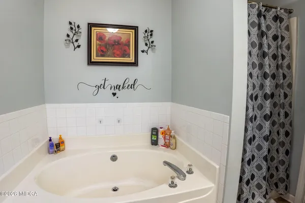 a bathroom with a bathtub and a sink
