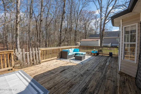 a view of a deck with wooden floor and outdoor seating