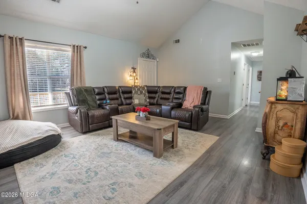 a living room with furniture and a fireplace