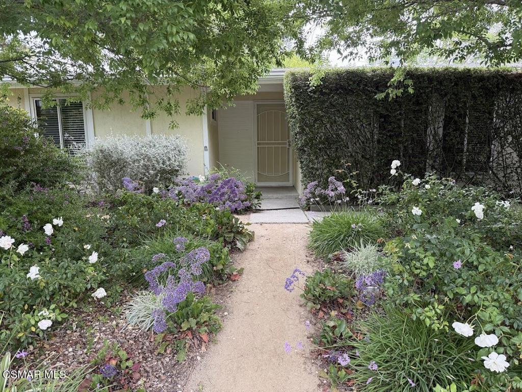 1306 Windsor Drive Thousand Oaks, CA 91360 - Photo 13 of 14 a front view of a house with a yard and potted plants