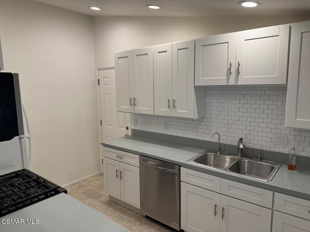 1306 Windsor Drive Thousand Oaks, CA 91360 - Photo 3 of 14 a kitchen with white cabinets a sink a stove and white cabinets