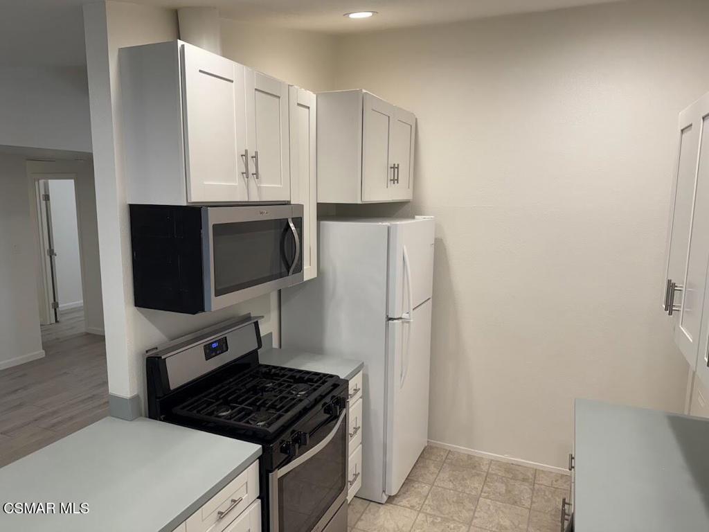 1306 Windsor Drive Thousand Oaks, CA 91360 - Photo 4 of 14 a kitchen with cabinets and appliances