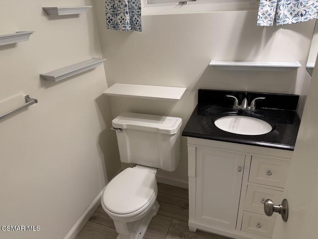 1306 Windsor Drive Thousand Oaks, CA 91360 - Photo 10 of 14 a white toilet sitting next to a bathroom sink
