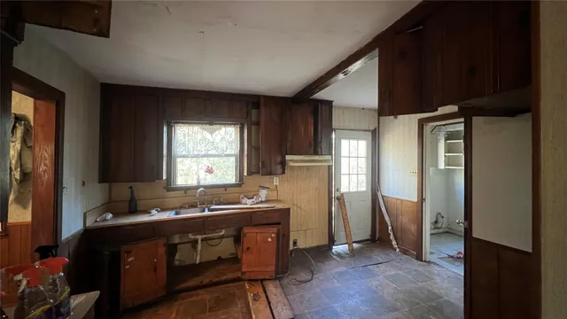 a room with wooden floor and furniture