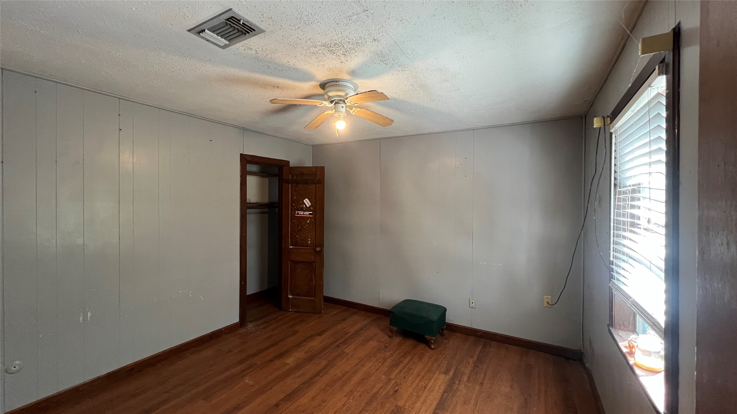 10111 Oberrender Road Fairchilds, TX 77461 - Photo 7 of 20 an empty room with wooden floor and windows