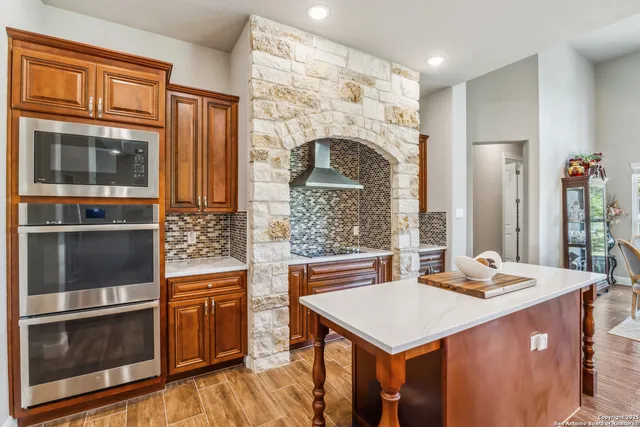 a kitchen with a stove refrigerator and a microwave oven
