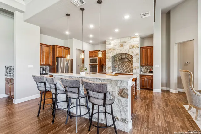 a dining table chairs and a chandelier