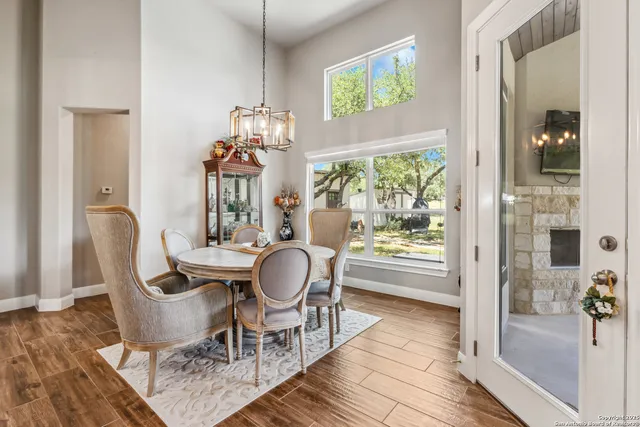 a dining room with furniture and wooden floor