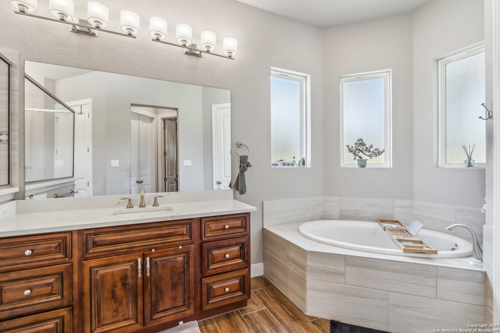 2319 Cascada Parkway Spring Branch, TX 78070 - Photo 17 of 32 a bathroom with a sink double vanity granite tub and a mirror