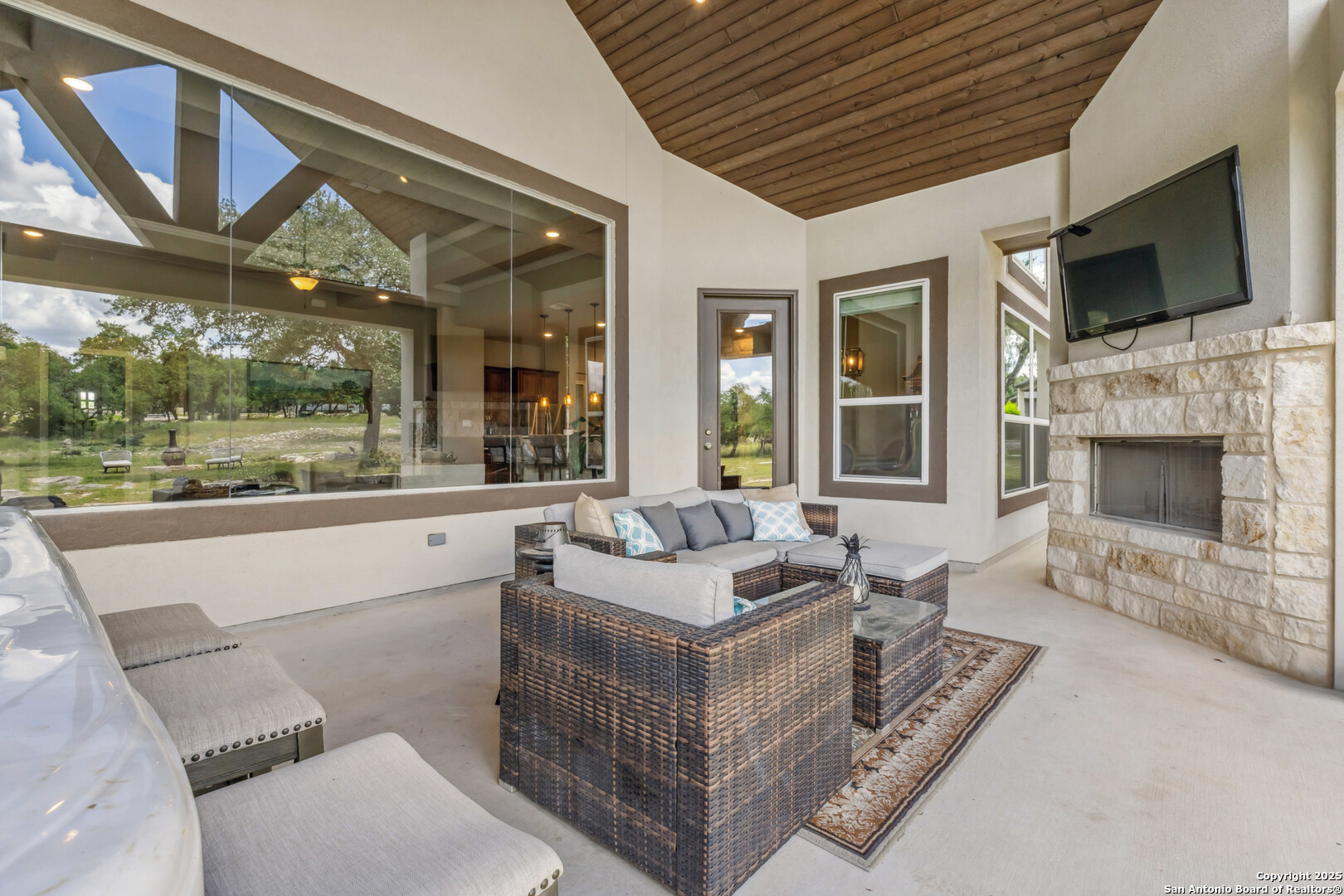 2319 Cascada Parkway Spring Branch, TX 78070 - Photo 2 of 32 a living room with fireplace furniture and a flat screen tv