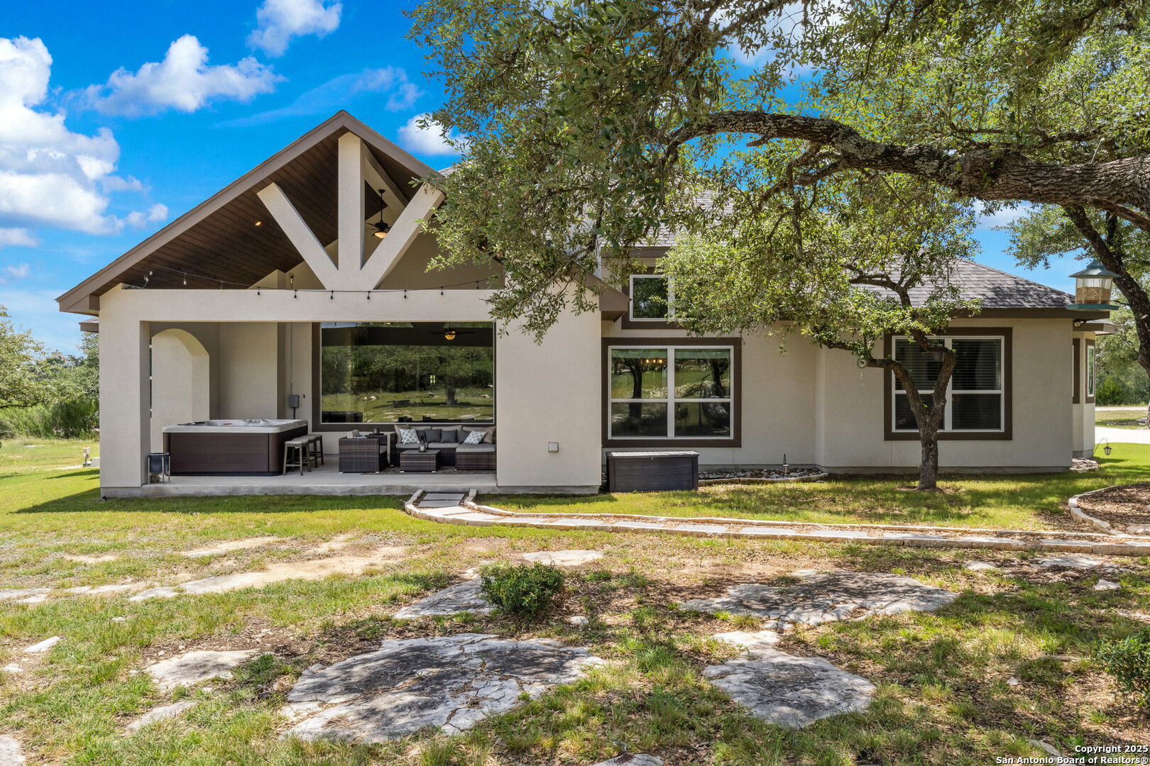 2319 Cascada Parkway Spring Branch, TX 78070 - Photo 23 of 32 a view of a house with swimming pool and porch with furniture