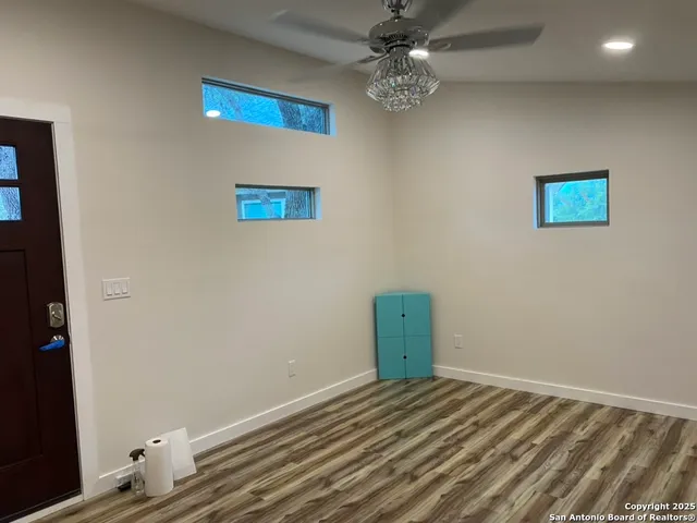 a view of a room with wooden floor