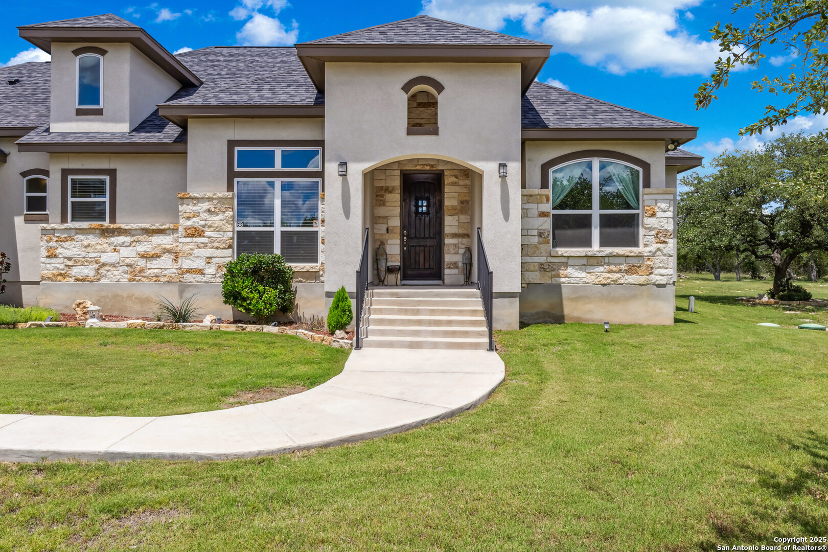 2319 Cascada Parkway Spring Branch, TX 78070 - Photo 7 of 32 a front view of a house with garden