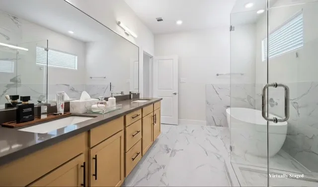 a bathroom with a bathtub and shower