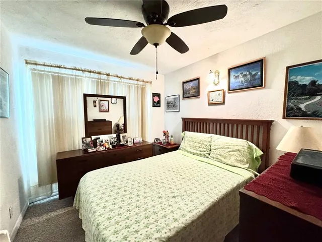 a bedroom with bed and a chandelier