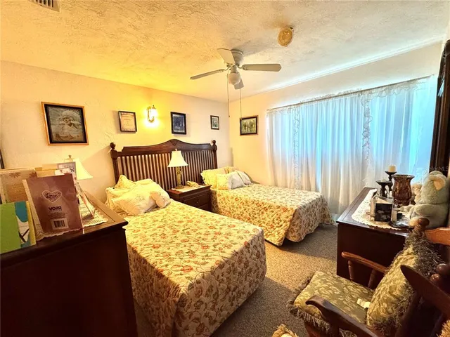 a bedroom with two beds and a couch