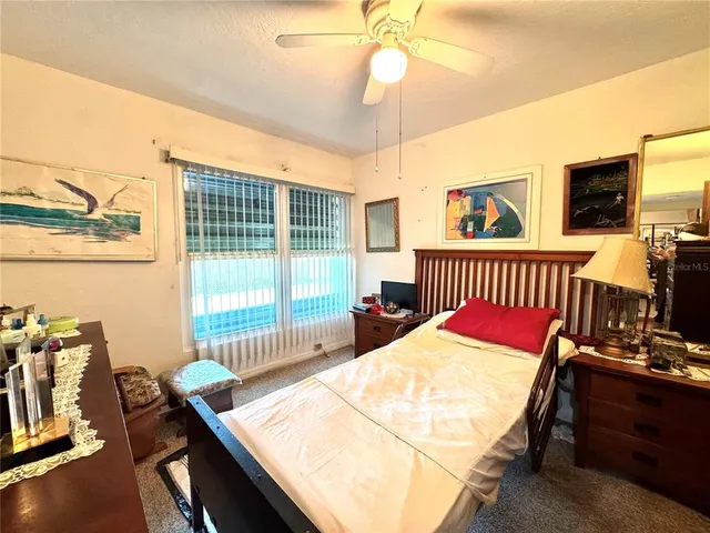 a bedroom with a bed and a table