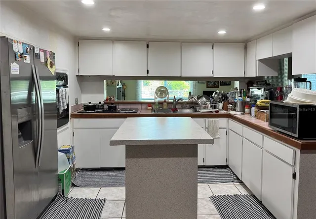 a kitchen with a sink stainless steel appliances and cabinets