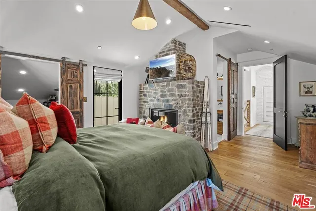 a bed room with a bed and a fireplace