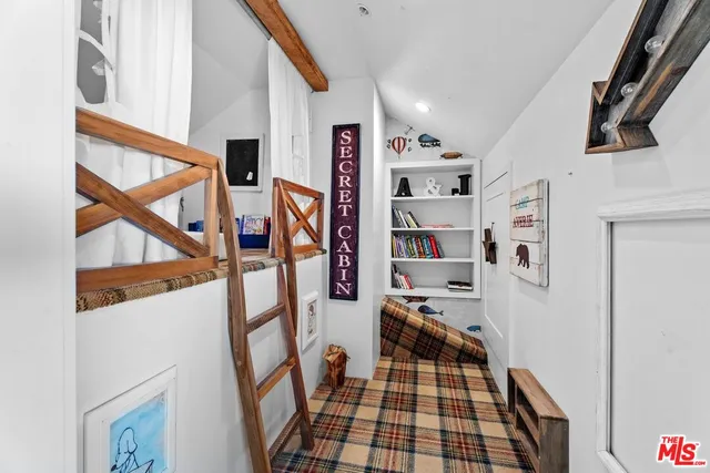 a hallway with a white stove top oven and cabinets