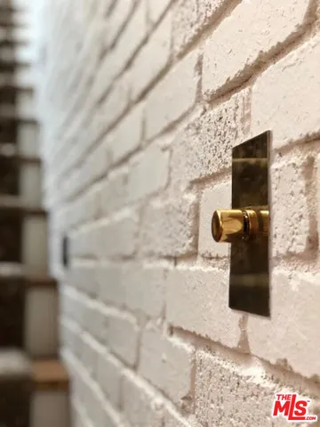 a bathroom with a granite countertop double vanity and a shower