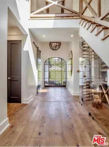 a view of an entryway with wooden floor