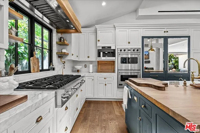 a kitchen with stainless steel appliances granite countertop a sink stove and cabinets