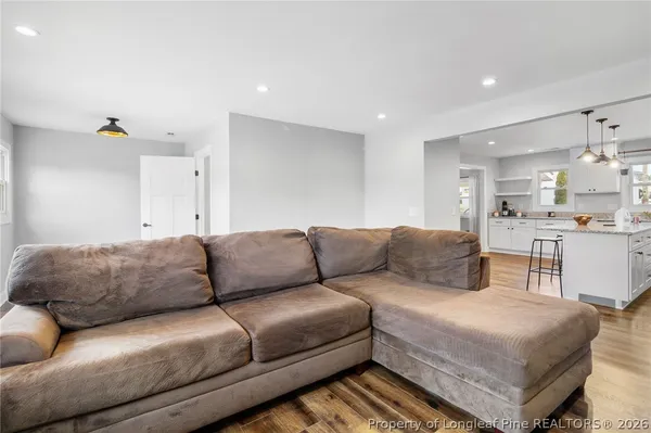 a living room with furniture and kitchen view