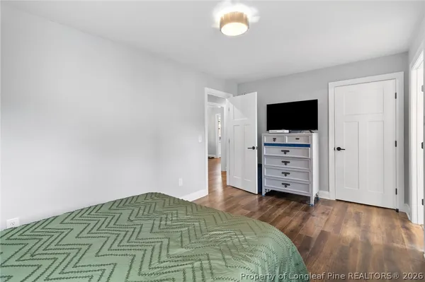 a bedroom with a bed and flat screen tv
